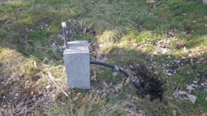 Image of sprinkler hose set up through brick