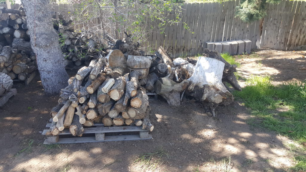 Long branches cut and stacked neatly on a pallet