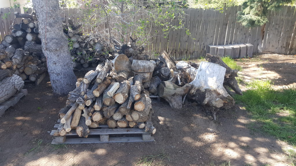 Branches stacked neatly on a pallet.