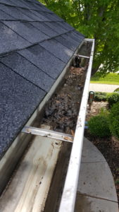 Rain gutter full of sludge