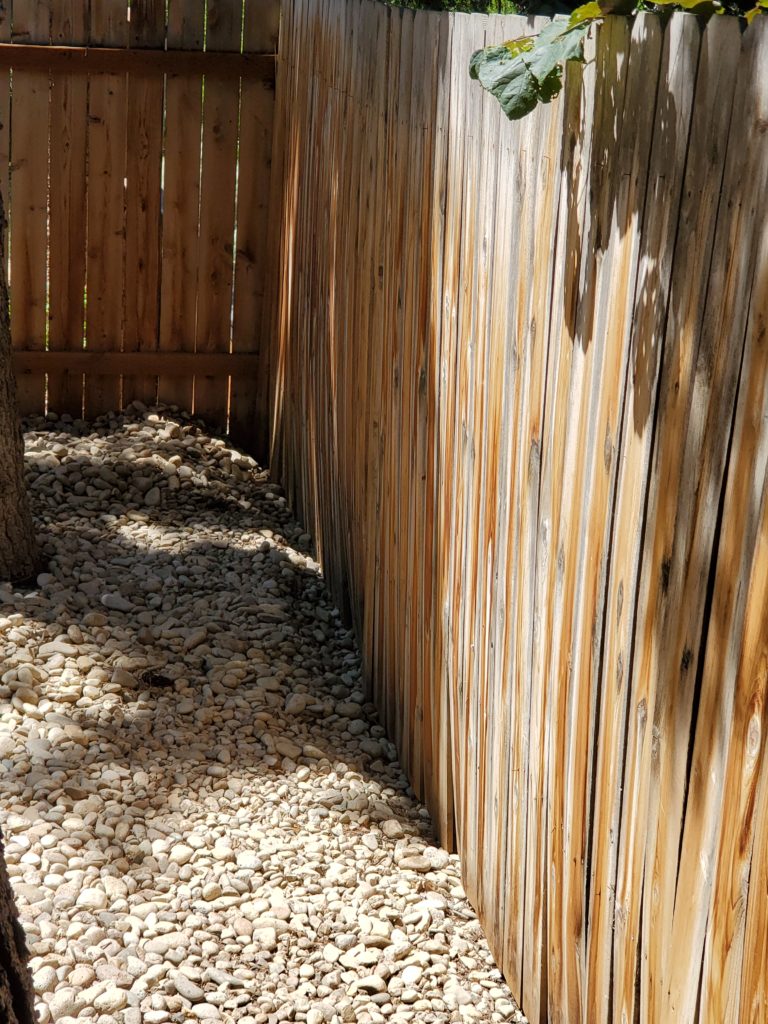 Image of a repaired fence that was warped