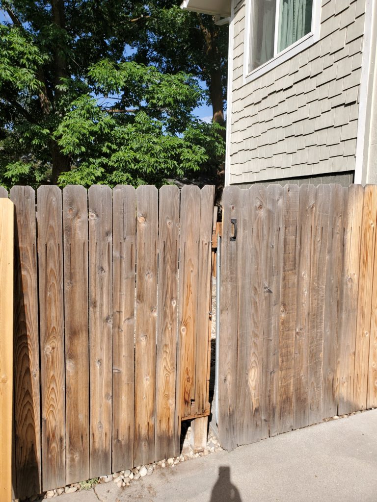 Image of a before shot of replaced gate pickets