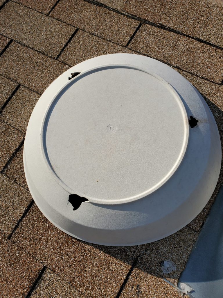 Image of attic fan cover after a styrong wind blew it off the fan