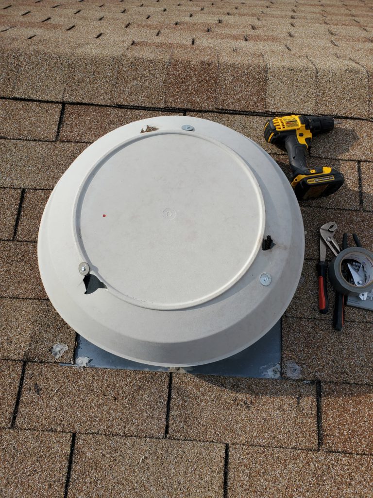 Image of out-of-date attic fan cover being re-used temporarily