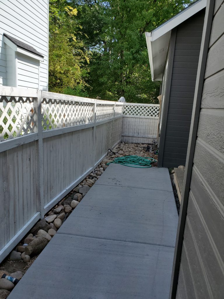 Image of white washed backyard fence