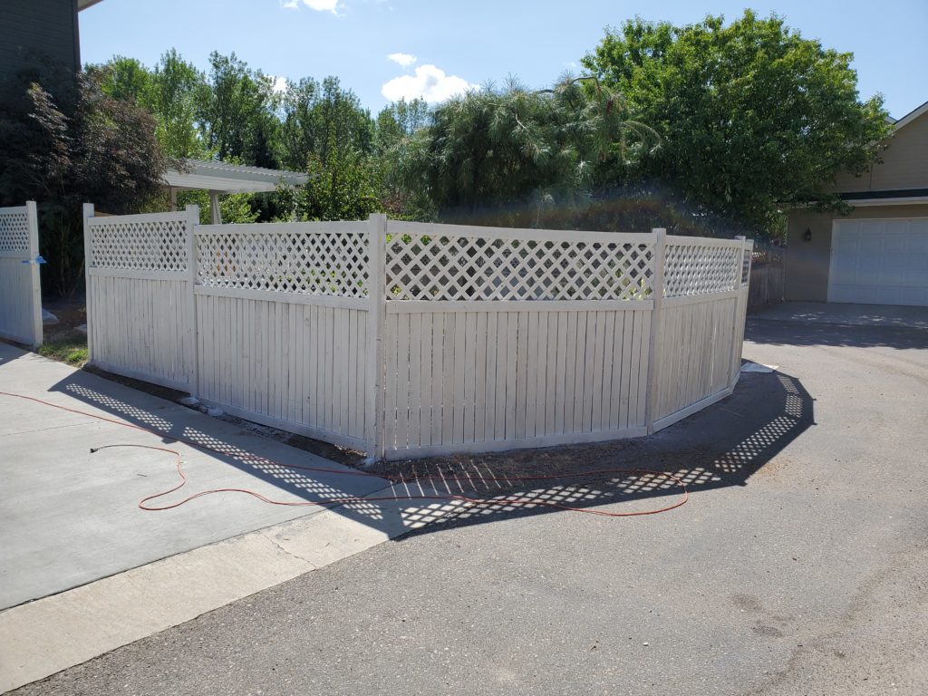 Image of white washed backyard fence